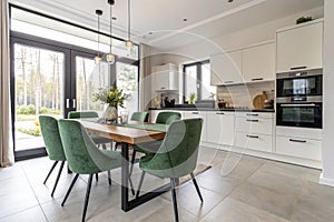 Modern kitchen with green suede chairs