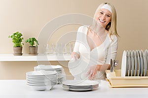 Modern kitchen - happy woman washing dishes