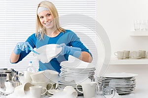 Modern kitchen - happy woman washing dishes