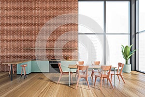 Modern kitchen interior with copy space on red brick wall, wooden countertops with a built in sink and a cooker. mock up. Loft