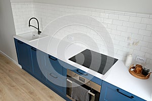 Modern kitchen interior design. Nordic style blue cabinets and white countertop top view