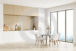 Modern kitchen interior, dining area with panoramic windows. Furnished by table and chairs for eating. Parquet floor