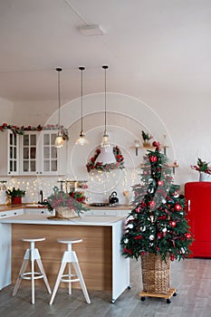 Modern Kitchen Interior with Island, Sink, Cabinets in New Luxury Home Decorated in Christmas Style.