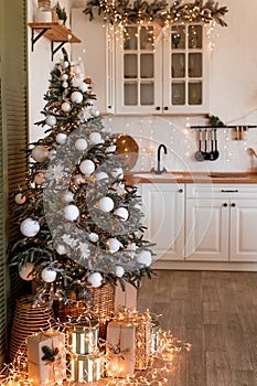 Modern Kitchen Interior with Island, Sink, Cabinets in New Luxury Home Decorated in Christmas Style.