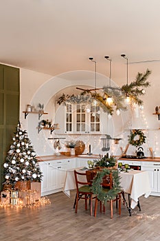 Modern Kitchen Interior with Island, Sink, Cabinets in New Luxury Home Decorated in Christmas Style.