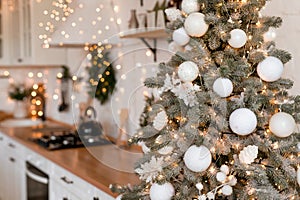 Modern Kitchen Interior with Island, Sink, Cabinets in New Luxury Home Decorated in Christmas Style.