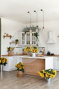 Modern Kitchen Interior with Island, Sink, Cabinets, and Sunflowers in New Luxury Home.