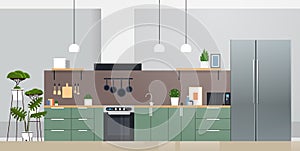 Modern kitchen interior with new refrigerator oven and microvawe home appliances concept photo