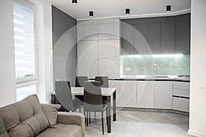 Modern kitchen interior with white and gray walls