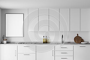 Modern kitchen interior with white walls  modern countertops with a built in sink and a cooker. Poster on white wall. 3d rendering