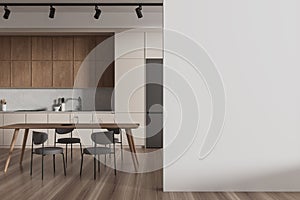 A modern kitchen interior with wooden cabinetry, furniture, and an empty white wall for mockups, on a light background, concept of photo