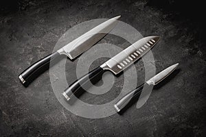 Modern Kitchen Knives Set on Stone Background. Chef's Knives Concept.