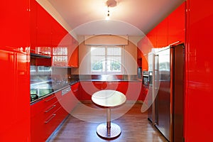 Modern kitchen lacquered with red photo