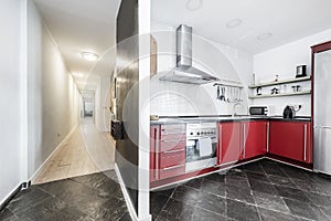 Modern kitchen with red furniture with drawers, stainless steel appliances