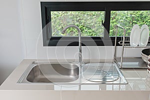 modern kitchen room with sink on counter