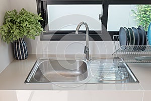 modern kitchen room with sink on counter