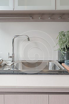 modern kitchen room with sink on top granite counter