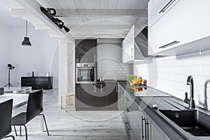 Modern kitchen with rustic ceiling