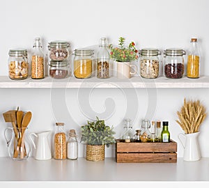 Modern kitchen shelves with various food ingredients on white background