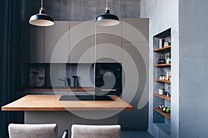 Modern kitchen with table and built-in hob.