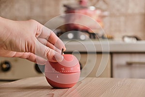 Modern kitchen timer apple shaped on the background of the kitchen