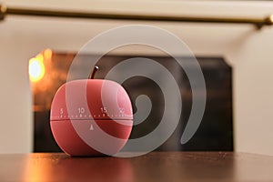 Modern kitchen timer apple shaped on the background of the kitchen