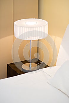 Modern lamp standing on the bed side table in the bedroom