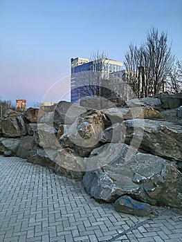 Modern landscape park. Glass skyscraper. City environment.