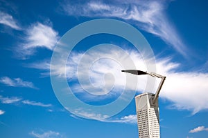 Modern lantern against a blue sky with clouds