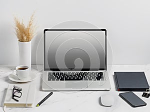 Modern lap top template mock up on white and clean work desk with blank screen Workspace desk, laptop, coffee cup and pen. laptop