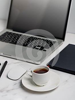 Modern lap top template mock up on white and clean work desk with blank screen Workspace desk, laptop, coffee cup and pen. laptop