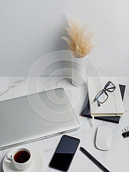 Modern lap top template mock up on white and clean work desk with blank screen Workspace desk, laptop, coffee cup and pen. laptop