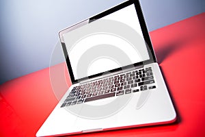 Modern laptop closeup on red modern desk