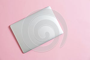 Modern laptop on color background