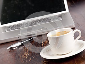 Modern laptop with a cup of coffee