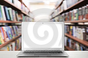 Modern laptop with empty screen on table in library