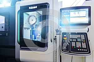 Modern lathe with CNC and workpiece and transparent windows for process control