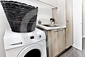 Modern laundry room with a washing machine and basket