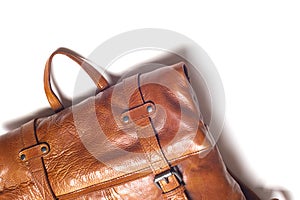 Modern leather backpack on a white background. Stylish accessory close-up. View from above