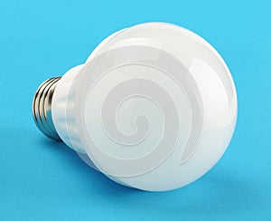Modern LED light bulb isolated on the blue background