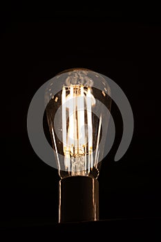 Modern LED light bulb similar to vintage filament lamp