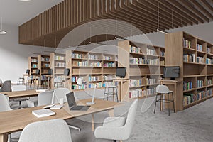 Modern library interior with table and chairs in row, pc computer and shelf