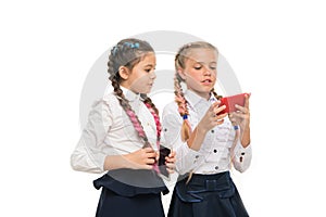 Modern life. Worldwide net. Internet resource has hazards for kids. Girls school uniform surfing internet. Schoolgirls