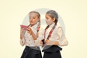 Modern life. Worldwide net. Internet resource has hazards for kids. Girls school uniform surfing internet. Schoolgirls