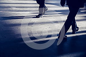 Modern lifestyle ground view of two busy men in different shoes walking with motion blur in urban city subway a weekday morning