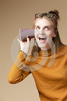 Modern lifestyle Ideas. Smiling Positive Caucasian Blond Girl Listening To Arcane Hidden Gossips and Secrets Using Disposable