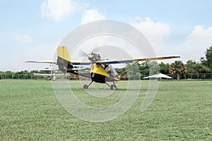 Modern light aircraft on green grass outdoors