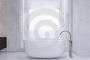 Modern light concrete minimalistic bathroom interior with white bathtub and mock up banner on wall.