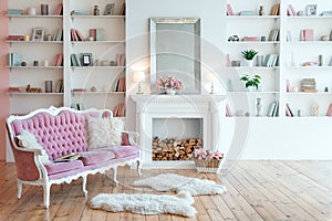 Modern light interior with fireplace, spring flowers and cozy pink sofa