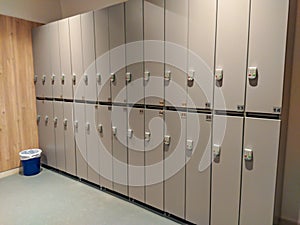 Modern and light locker room for schools or gyms with all lockers closed and locked for protection of the personal belongings